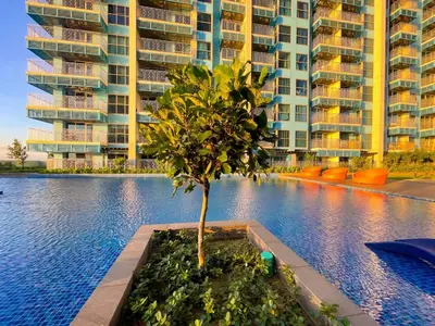 a tree in a planter in front of a building at Ultra Luxury 6BR near Solaire, Okada, & Airport in Manila