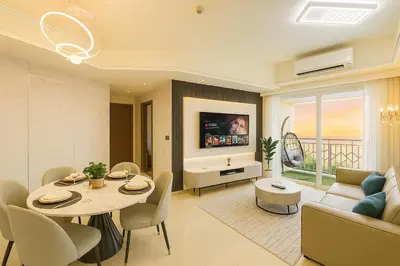 a living room with a table and a couch and a tv at Ultra Luxury 6BR near Solaire, Okada, & Airport in Manila