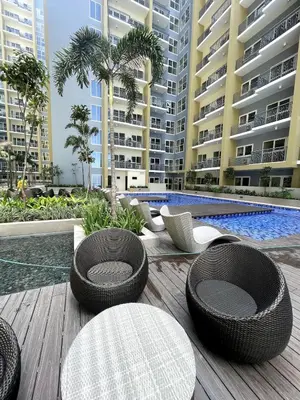 a patio with some chairs and tables and buildings at Ultra Luxury 6BR near Solaire, Okada, & Airport in Manila