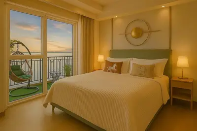 a bedroom with a large bed and a balcony at Lovely & Luxury 1BR near Solaire, Okada w Sunset in Manila