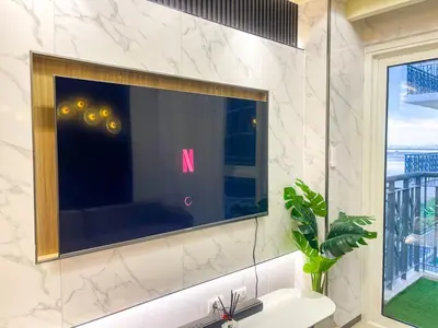 a bathroom with a large television on the wall at Lovely & Luxury 1BR near Solaire, Okada w Sunset in Manila