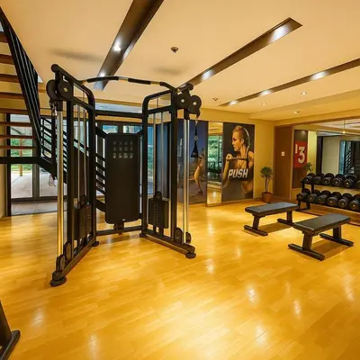 a gym with treadmills and weights in a room at Spacious 2BR near Solaire, Okada, Airport in Manila