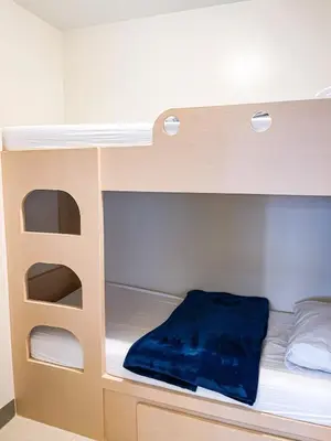 a bunk bed with a blue blanket on the bottom bunk at Spacious 2BR near Solaire, Okada, Airport in Manila