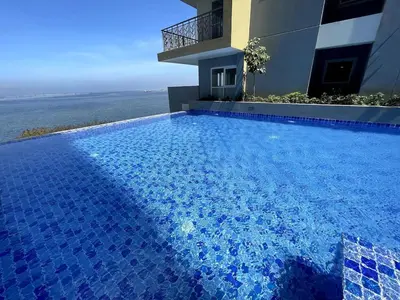 a swimming pool in front of a house at Spacious & Luxury 1BR near Solaire, Okada, Airport in Manila
