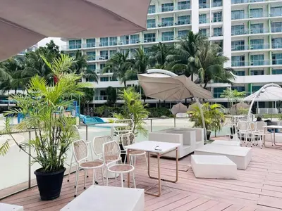 a patio with tables and chairs and a building at SM Bicutan Staycation Bahamas in Manila