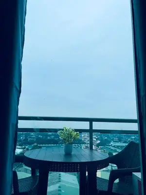 a table with a potted plant on a balcony at SM Bicutan Staycation Bahamas in Manila