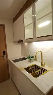 a kitchen counter with a sink and a faucet at Luxury Condotel Manila by MOA in Manila