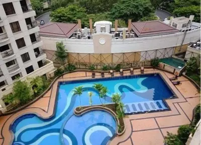 an overhead view of a large swimming pool on a building at Forbes Town in Manila