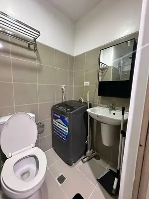 a small bathroom with a toilet and a sink at Shore Residences Mall of Asia in Manila