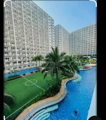a view of a large apartment building with a soccer field at Shore Residences Mall of Asia in Manila