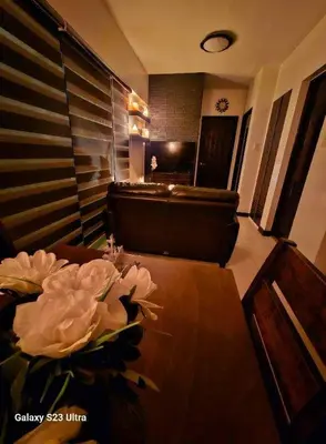 a living room with a couch and a table with a flower at 2BR FREE PARKING Calathea Place in Manila