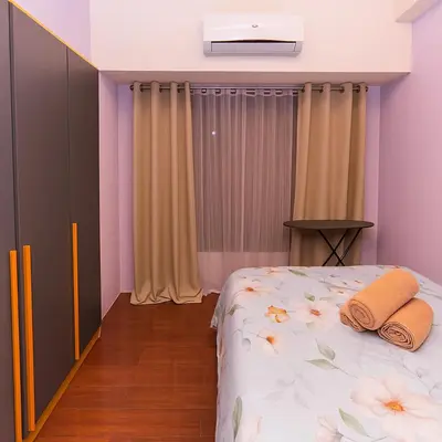 a bedroom with a bed with two towels on it at Royal rise majestic Makati staycation 5338 in Manila