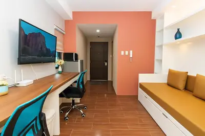 an office with a long desk and chairs at Metro mood haven Makati relax recharge repeat 1765 in Manila