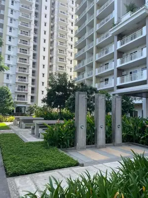 a park in front of a large apartment building at The Atherton by DMCI- 2BR FREE PARKING in Manila