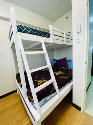 a white bunk bed with a ladder in a room at The Atherton by DMCI- 2BR FREE PARKING in Manila