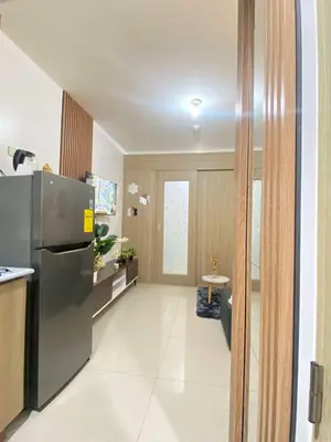 a kitchen with a stainless steel refrigerator in a room at Leisure Suite Staycation in Manila