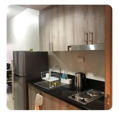 a kitchen with a sink and a refrigerator at Shore 2 Residence Staycation 1 in Manila