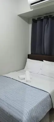 a bed with two white towels on top of it at Shore 2 Residence Staycation 1 in Manila