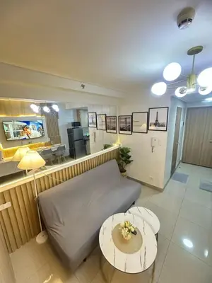 a living room with a couch and a table at Shore 2 Residence Staycation 1 in Manila