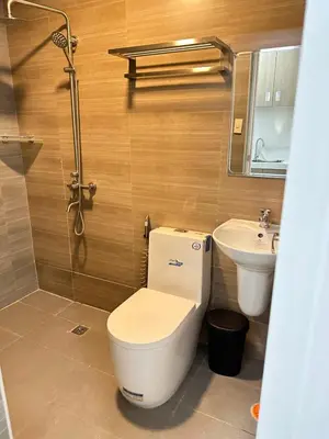 a bathroom with a toilet and a sink at Gimaca Boutique Hotel in Manila