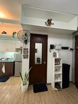a room with a kitchen and a door with a fan at Peaceful Getaway in Manila