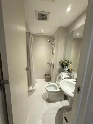 a bathroom with a toilet and a sink at Azure Residences Getaway in Manila