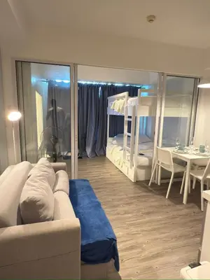 a living room with a couch and a room with a bedroom at Azure Residences Getaway in Manila