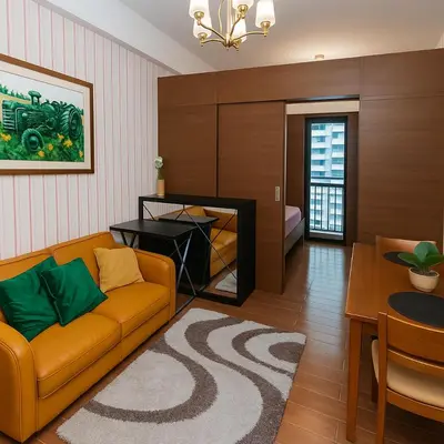 a living room with a couch and a table at Serene Stay Air Makati Boutique Comfort City Perks 1767 in Manila