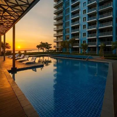 a swimming pool with a sunset in the background at Luxury 3BR near Solaire, Airport II Infinity Pool in Manila