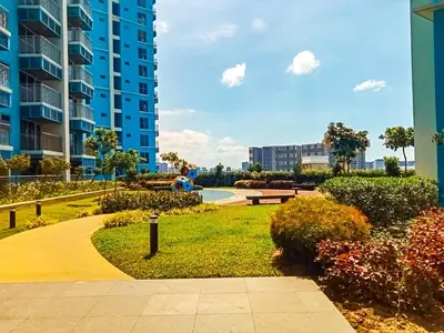 a park in front of a tall apartment building at Luxury 3BR near Solaire, Airport II Infinity Pool in Manila