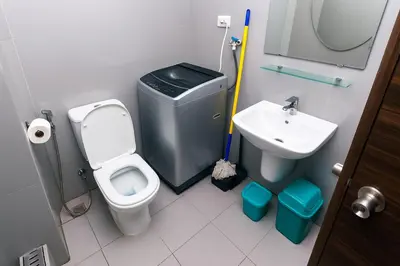 a small bathroom with a toilet and a sink at The Plush Pad Makati Ayala Views 300MB WiFi 1940 in Manila