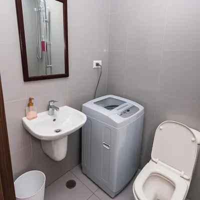 a bathroom with a toilet and a sink at Velvet Vibe Chic Makati Stay Pool Gym 4034 in Manila