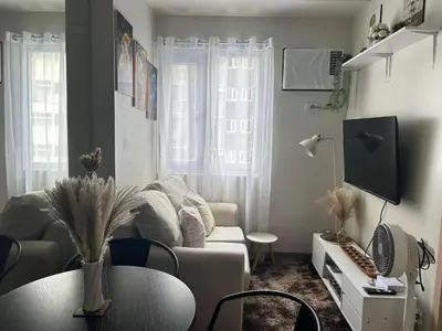 a living room with a couch and a table at The Minimal Getaway in Manila