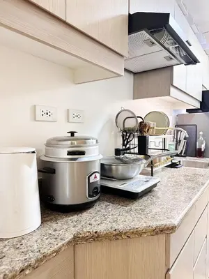a kitchen with a counter with pots and pans on it at Skyline Hideout in Sampong
