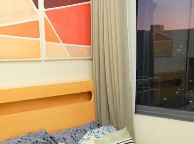 a bed next to a window with a curtain at Awsome Corner Unit at Shore 3 in Manila