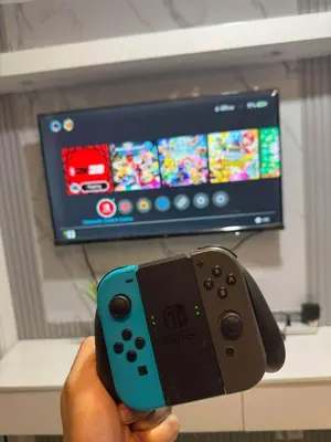 a person holding a video game controller in front of a tv at Azure Residences Penthouse in Manila