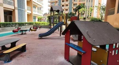 a playground with a slide and a slideintend at Premium 1BR suite Modern Filipino at BGC w balcony in Manila