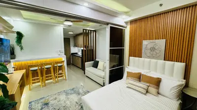 a bedroom with a bed and a living room at MOA Newly Turn Over 1 bedroom with balcony PRIER Place in Manila