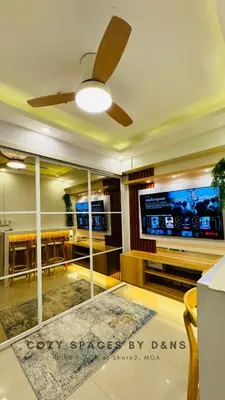 a living room with a ceiling fan and a tv at MOA Newly Turn Over 1 bedroom with balcony PRIER Place in Manila