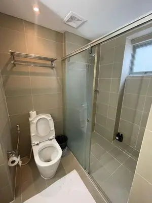 a bathroom with a toilet and a shower at Makati City Serenity Tower 2501 in Manila