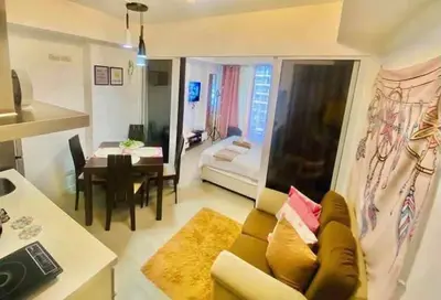 a living room with a couch and a table at Dream Catcher Theme Unit in Manila