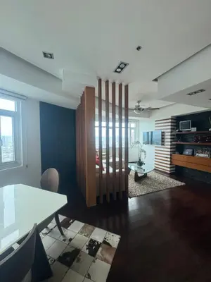 a living room with a table and a dining room at 4 Bedroom Luxury Condo in Ortigas in Manila