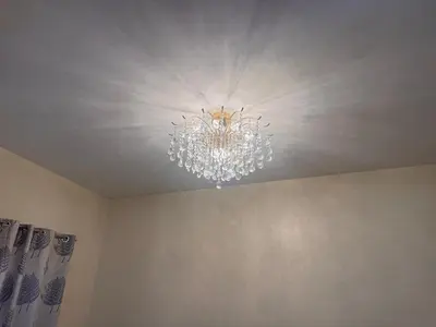 a chandelier hanging from a ceiling in a room at The Intramuros Suite in Manila