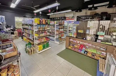 a store aisle of a grocery store with a lot of products at The Intramuros Suite in Manila