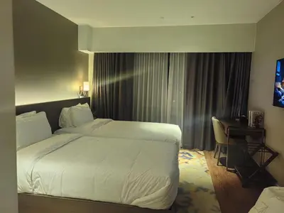 a hotel room with a large bed and a desk at Acqua Private Residences in Manila