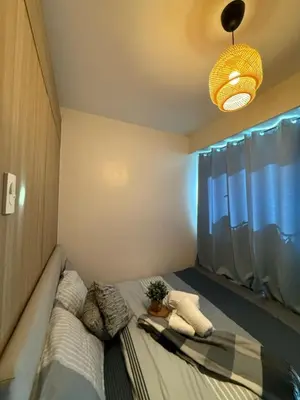 a bedroom with a bed with a potted plant on it at Near NAIA AIRPORT in Manila