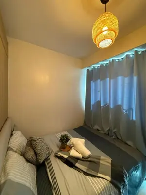 a bedroom with a bed with a potted plant on it at Near NAIA AIRPORT in Manila