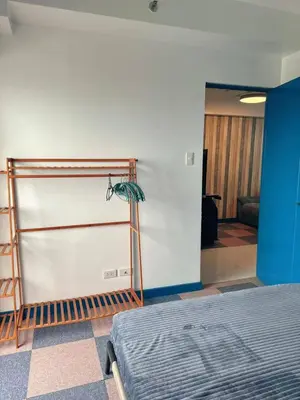 a room with a bed and a blue wall at Torre De Manila in Manila