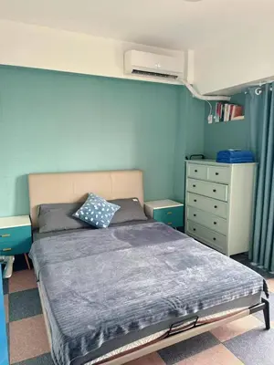 a bedroom with a bed and a dresser in it at Torre De Manila in Manila