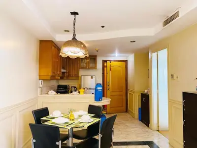 a dining room with a table and chairs in a kitchen at Seaview in Malate in Manila